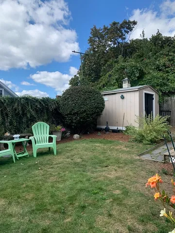 a view of a chair and table in the yard