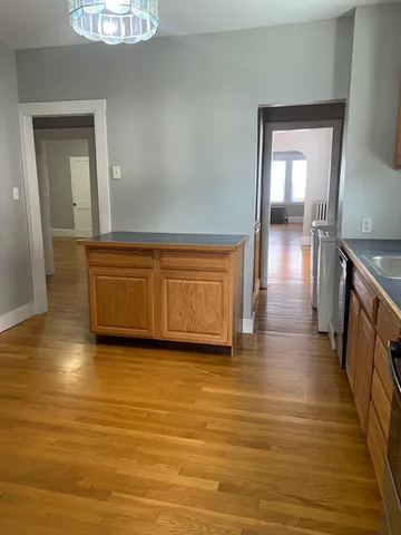 a view of a room with wooden floor and staircase