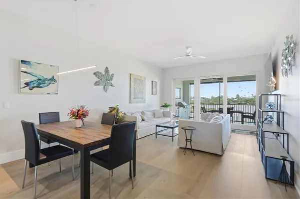 a large kitchen with stainless steel appliances a large window and a refrigerator