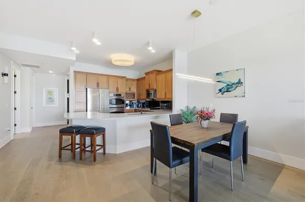 a kitchen with stainless steel appliances a refrigerator a sink a stove and cabinets