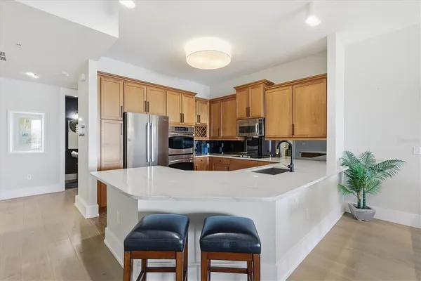 a kitchen with a sink white cabinets and appliances
