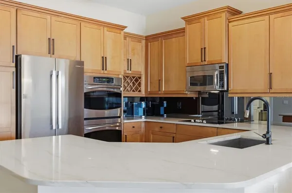 a kitchen with stainless steel appliances white cabinets and a counter space