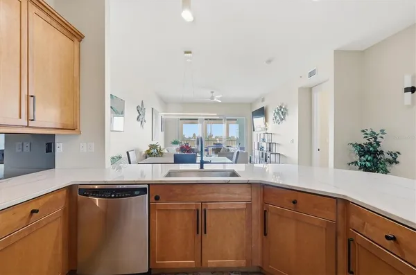 a kitchen with a sink dishwasher and cabinets
