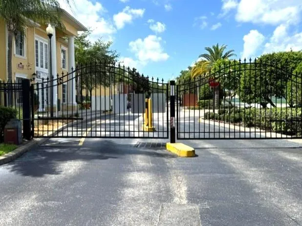 a view of a park with iron fence