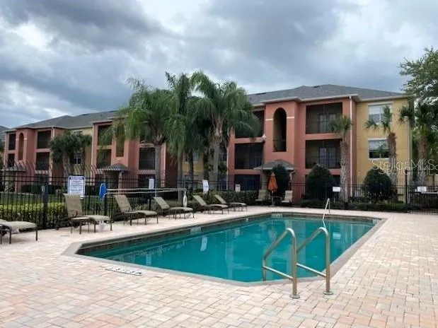 a view of a house with swimming pool and sitting area