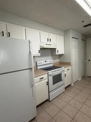 a white refrigerator freezer sitting inside of a kitchen
