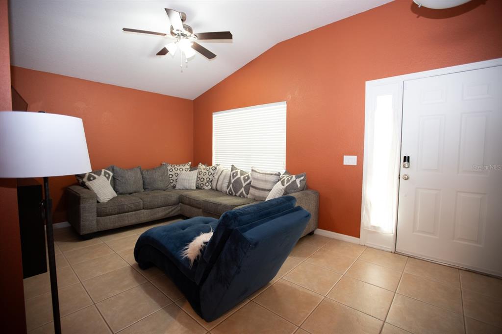 11617 Brookmore Way Riverview, FL 33569 - Photo 12 of 42 a living room with furniture and a ceiling fan