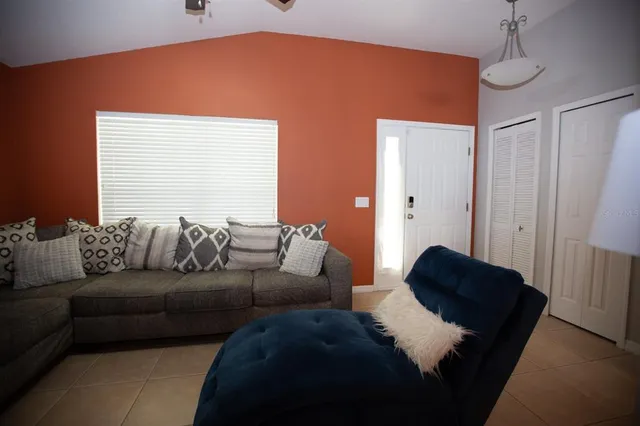 a living room with a couch and a dresser next to a window