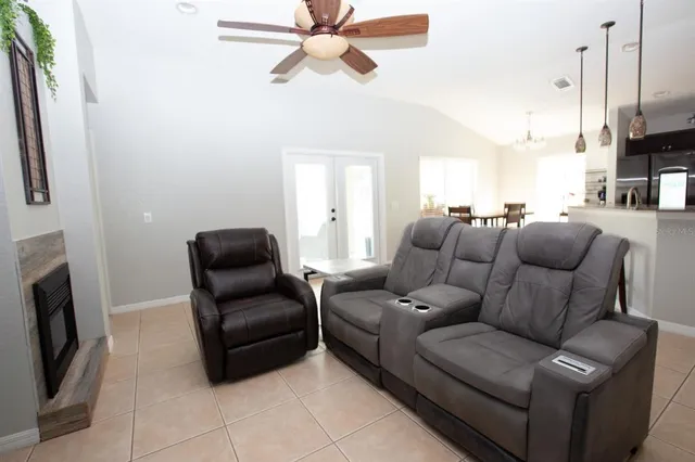 a living room with furniture a fireplace and a flat screen tv