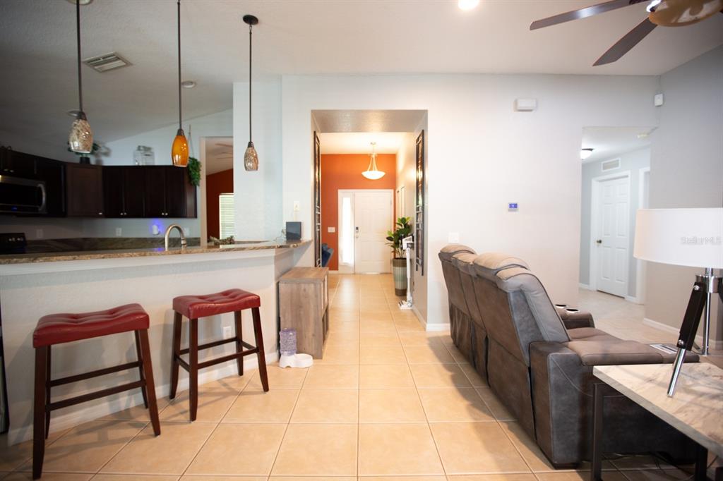 11617 Brookmore Way Riverview, FL 33569 - Photo 24 of 42 a living room with furniture a flat screen tv and a table