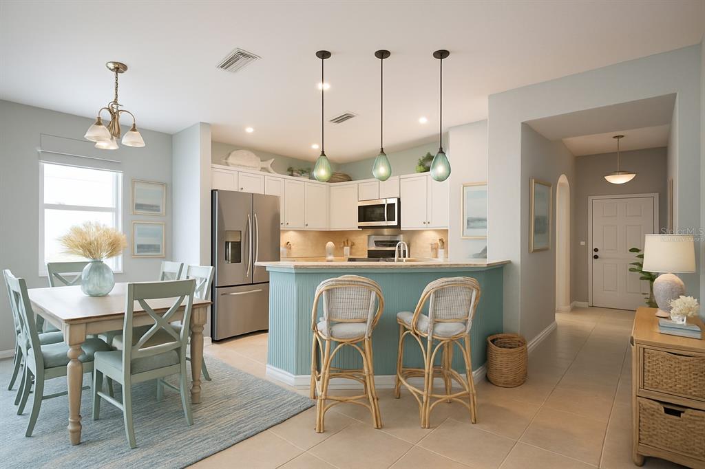 11617 Brookmore Way Riverview, FL 33569 - Photo 4 of 42 a view of a dining room and livingroom with furniture wooden floor a chandelier