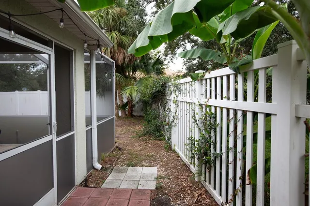 a view of a house with a small yard and floor to ceiling window