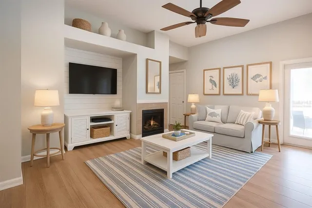 a living room with furniture a fireplace and a flat screen tv