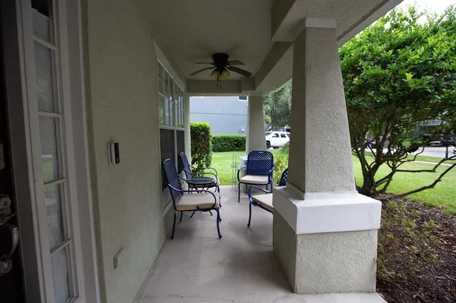 a porch with a table and a chairs