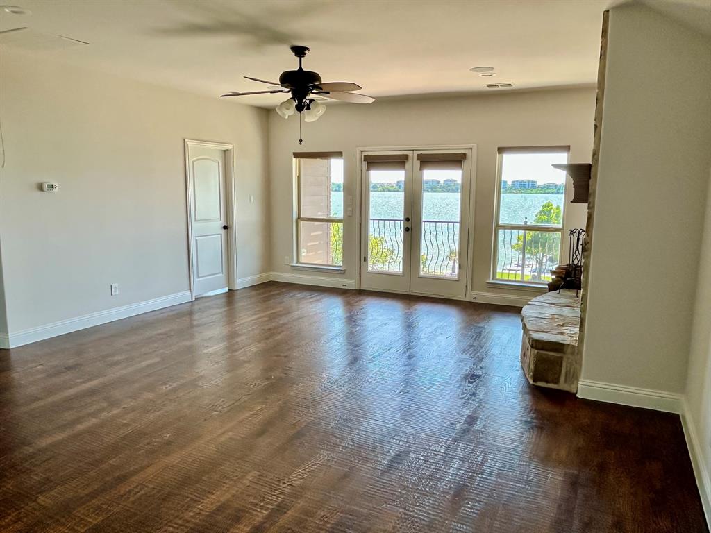 2313 Windjammer Way Rowlett, TX 75088 - Photo 5 of 38 a view of an empty room with a window and wooden floor
