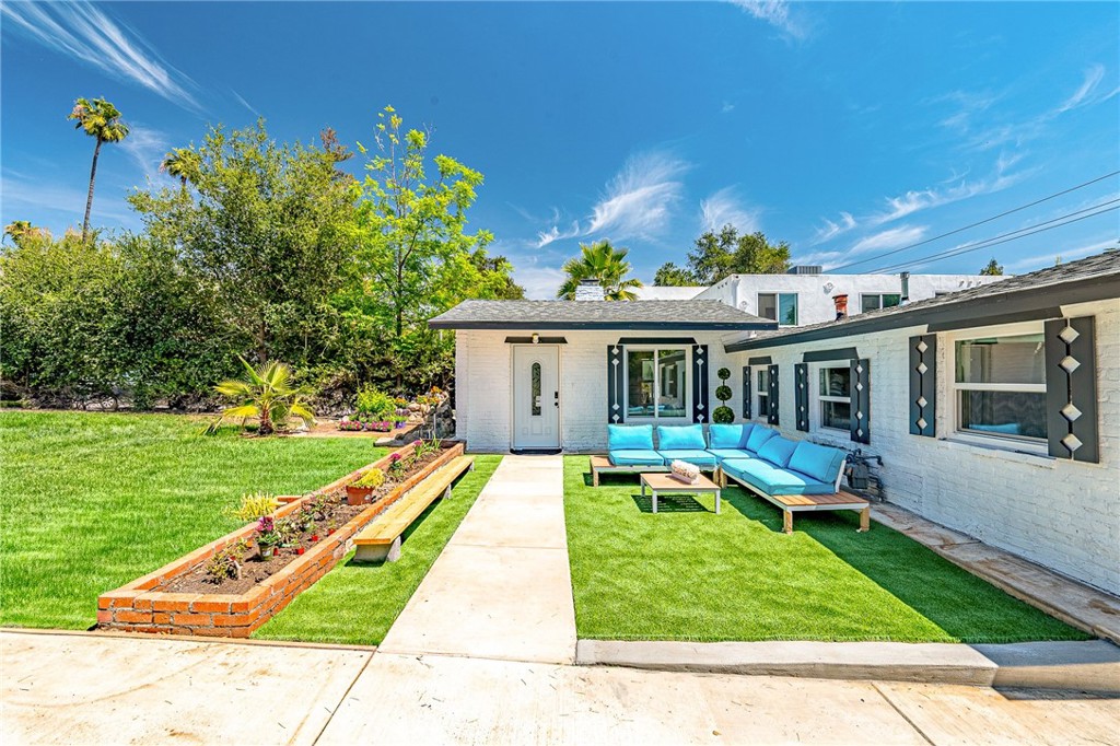 1280 East Woodbury Road Pasadena, CA 91104 - Photo 7 of 40 a view of a house with a yard porch and sitting area