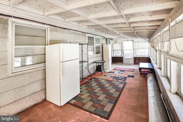 a storage room with wooden floor and a view of bedroom