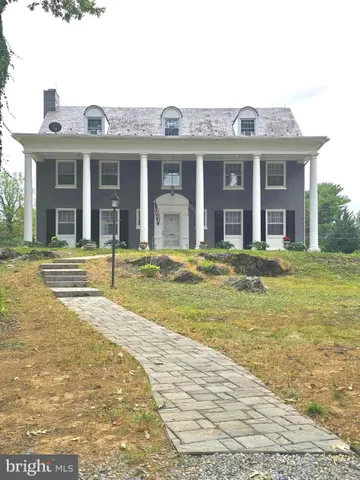 a view of a white house with a swimming pool