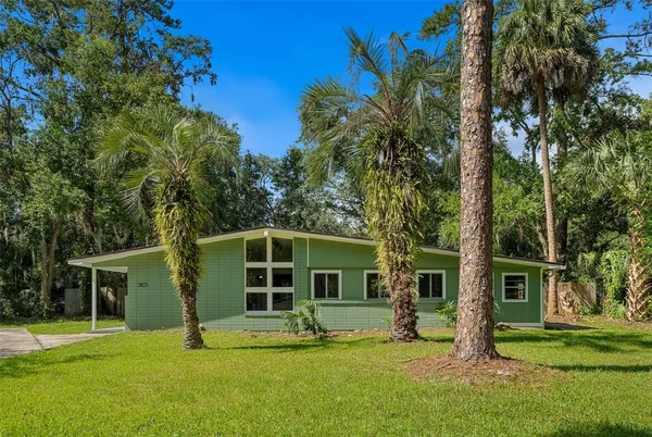 a view of a house with a yard in front of a house