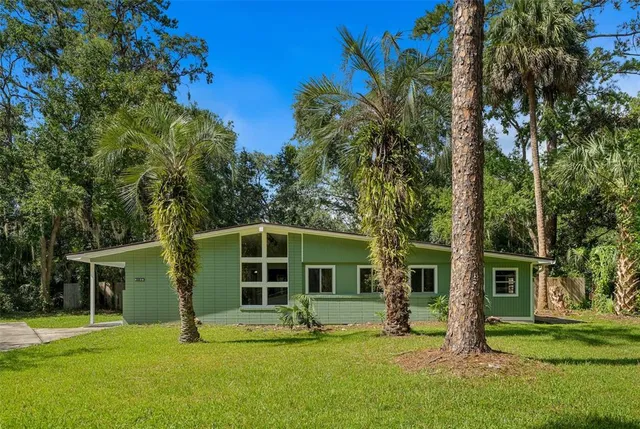 a view of a house with a yard in front of a house