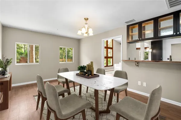 a view of a dining room with furniture and a chandelier