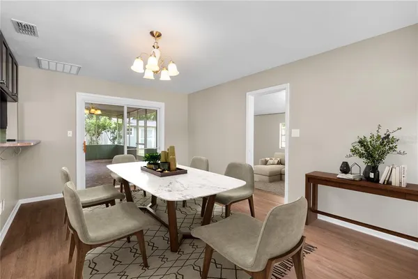 a view of a dining room with a table and chairs