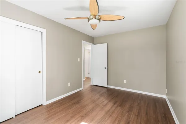 a view of an empty room with wooden floor