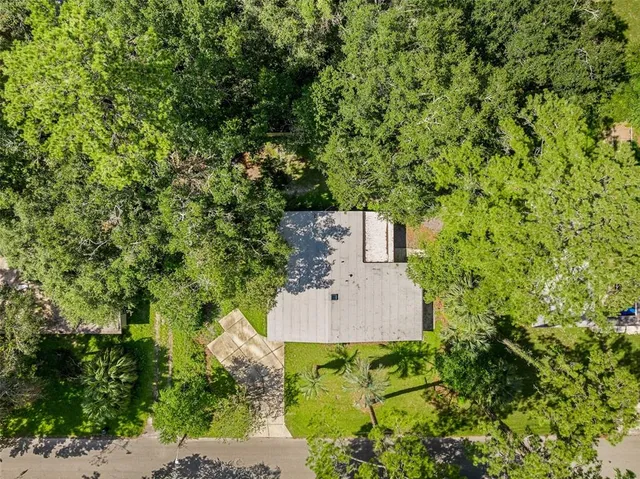 an aerial view of a house with a yard