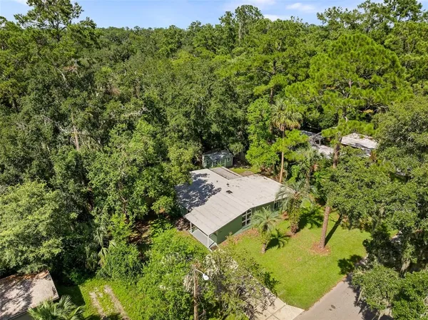 an aerial view of a house with yard swimming pool and outdoor seating