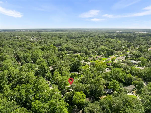 an aerial view of residential houses with outdoor and green space