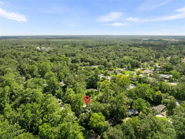 an aerial view of residential houses with outdoor and green space
