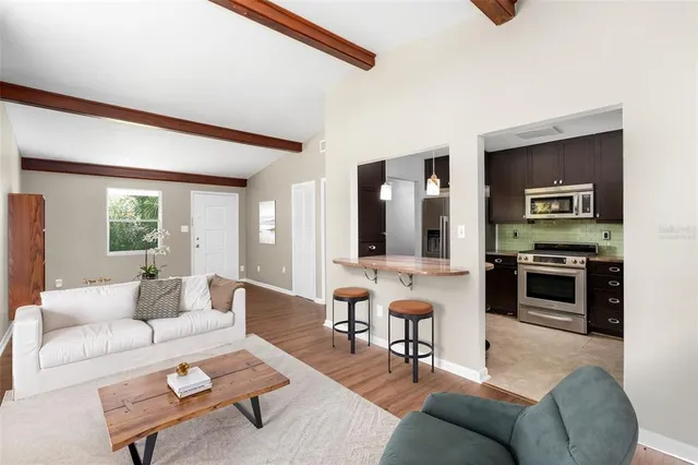 a living room with furniture and a kitchen
