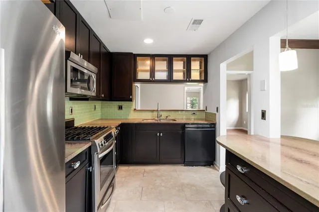 a kitchen with granite countertop stainless steel appliances and wooden cabinets