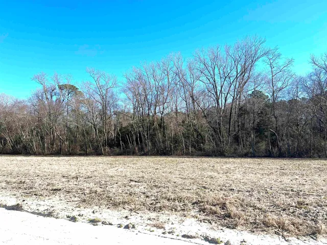 a view of a white house with a yard