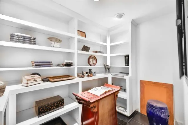 a balcony with chairs and with potted plants