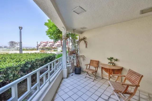 a dining room with a table chairs and a kitchen view