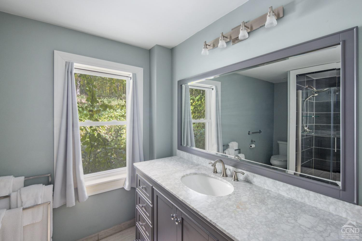 98 Goetz Road East Chatham, NY 12060 - Photo 13 of 28 a en suite bathroom with a granite countertop sink and a large mirror