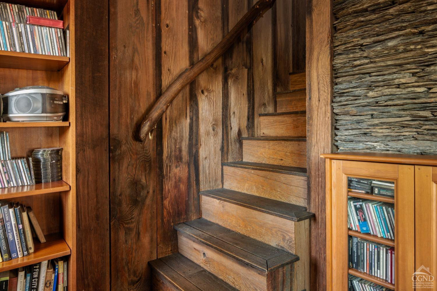 98 Goetz Road East Chatham, NY 12060 - Photo 14 of 28 a view of staircase with wooden floor and book shelf