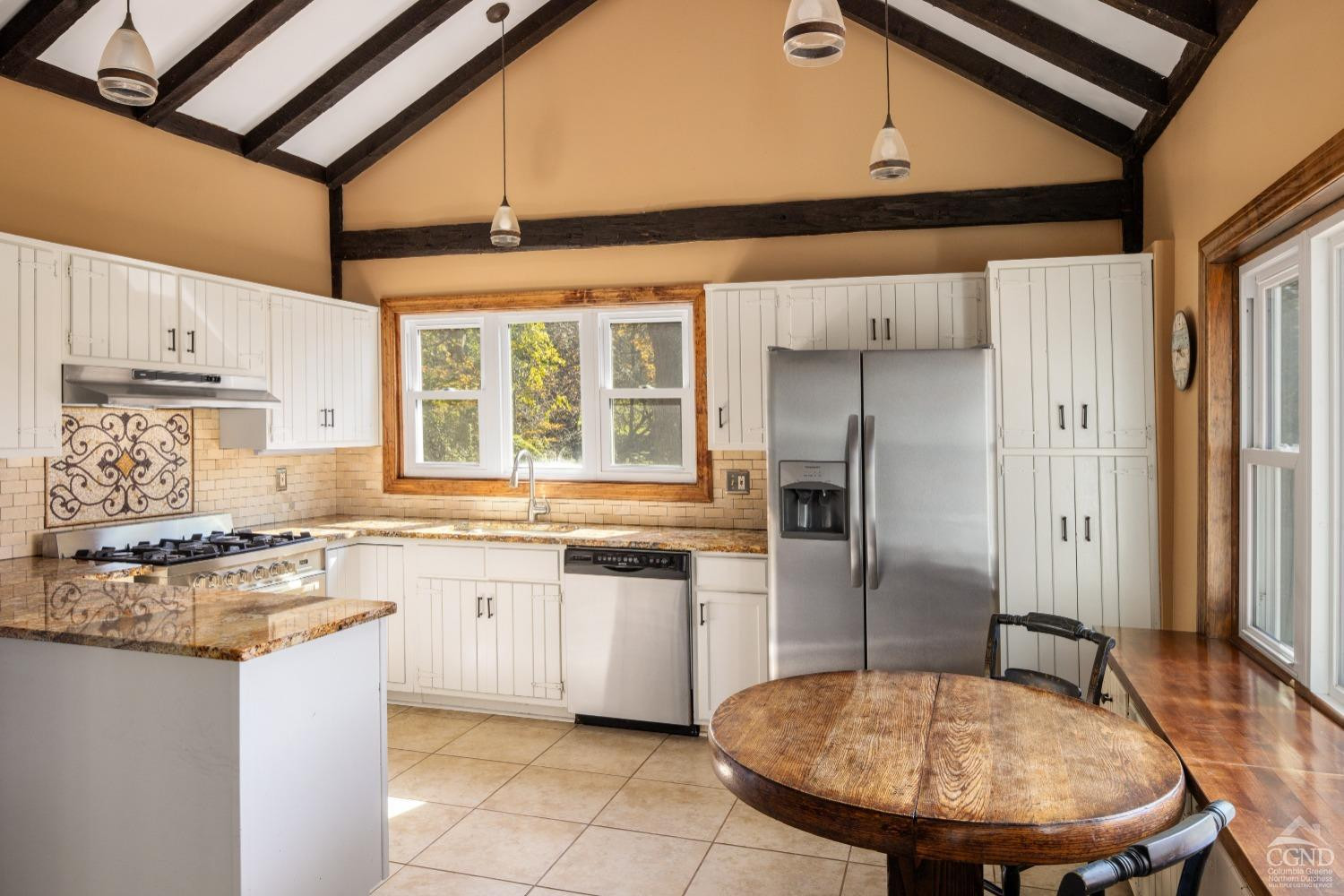 98 Goetz Road East Chatham, NY 12060 - Photo 4 of 28 a kitchen with stainless steel appliances granite countertop a sink a stove a refrigerator cabinets and dining table