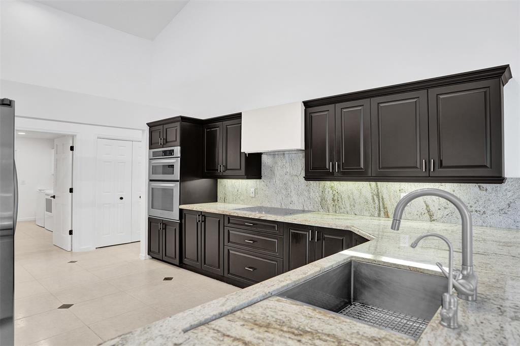 2891 Northwest 28th Terrace Boca Raton, FL 33434 - Photo 16 of 51 a kitchen with a sink and cabinets