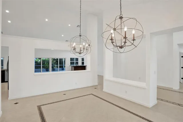 a view of an empty room with a fireplace and a window