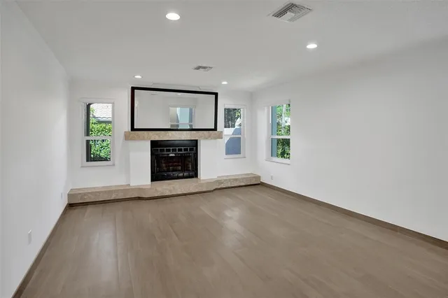a view of an empty room with a fireplace