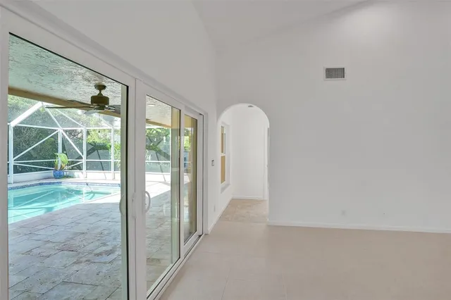 a kitchen with white cabinets and refrigerator