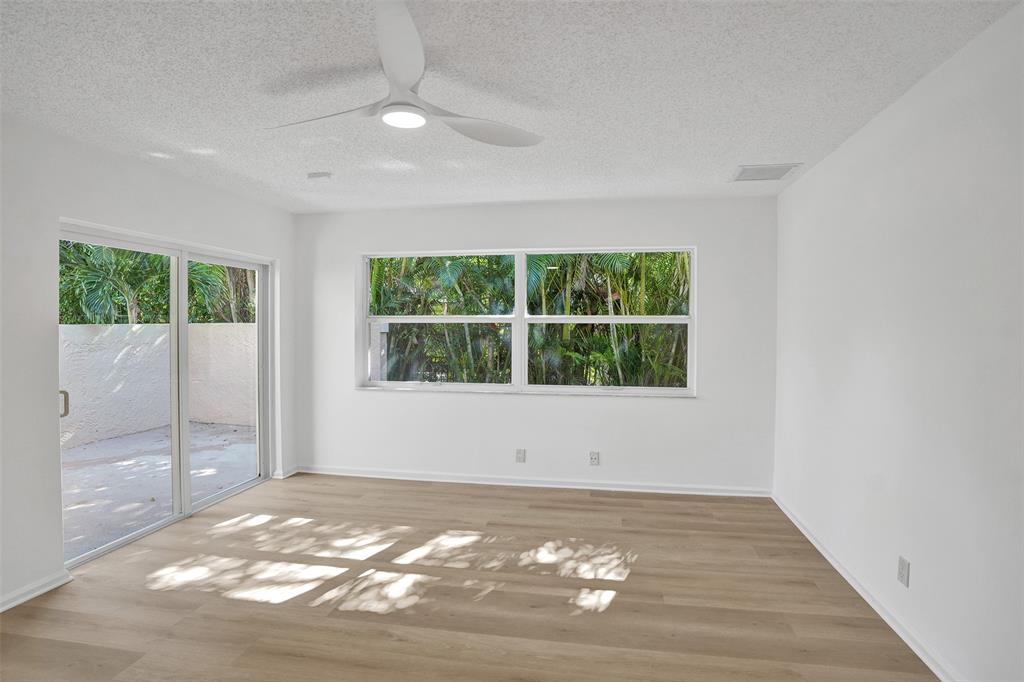 2891 Northwest 28th Terrace Boca Raton, FL 33434 - Photo 34 of 51 a view of an empty room with wooden floor and a window