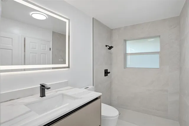 a view of a big room with wooden floor and windows