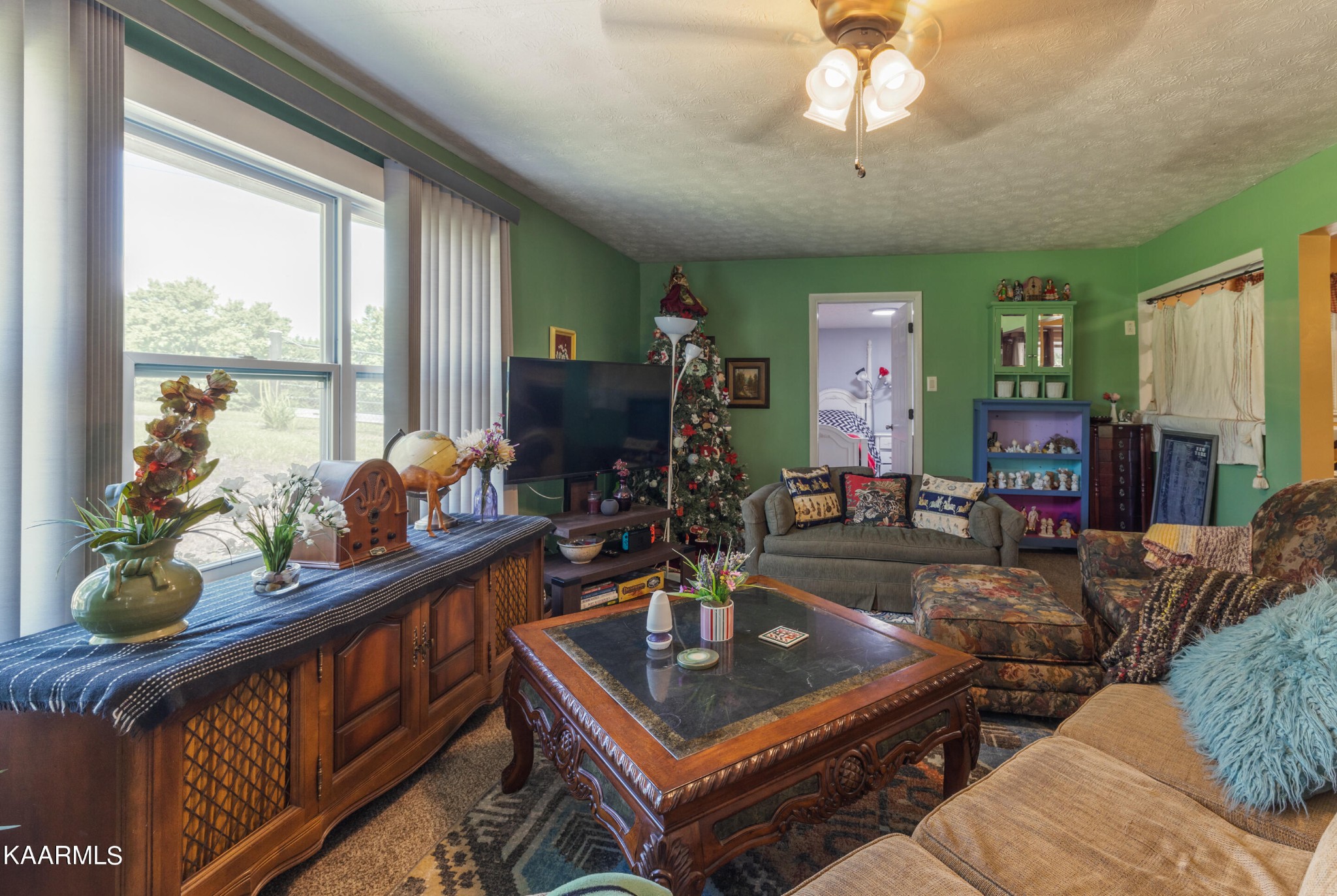 6719 Cate Road Knoxville, TN 37931 - Photo 3 of 30 a living room with furniture a flat screen tv and a large window