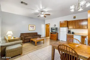 a living room with furniture and kitchen view