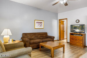 5829 East Buck Springs Road, Unit 252 Pinetop, AZ 85935 - Photo 2 of 27 a living room with furniture and a flat screen tv