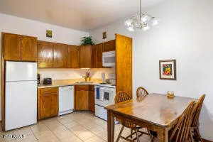 a kitchen with a table chairs refrigerator and microwave