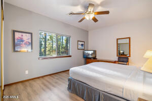 5829 East Buck Springs Road, Unit 252 Pinetop, AZ 85935 - Photo 8 of 27 a bedroom with a bed and a chandelier